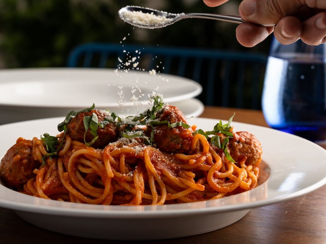 Classic Italian spaghetti and meatballs topped with basil and fresh parmesan at Simply Capri. A comforting dish that brings authentic flavors to Orlando.