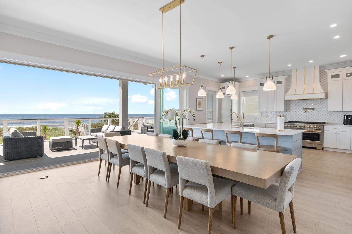 Open living area with wide sliding glass doors to the expansive outdoor seating area.