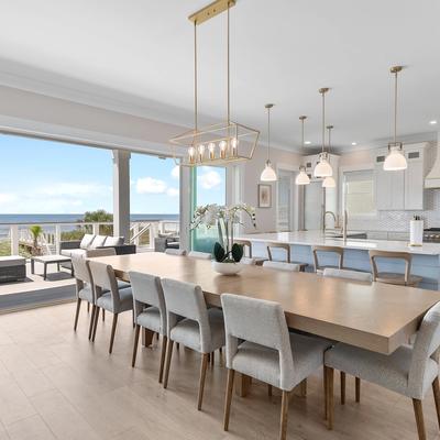 Open living area with wide sliding glass doors to the expansive outdoor seating area.