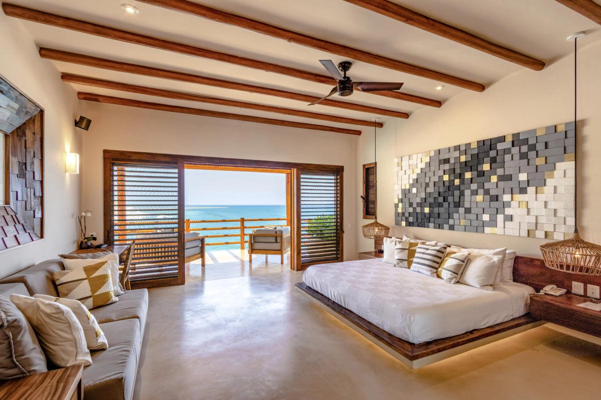 Bedroom with outdoor living space and sea views.