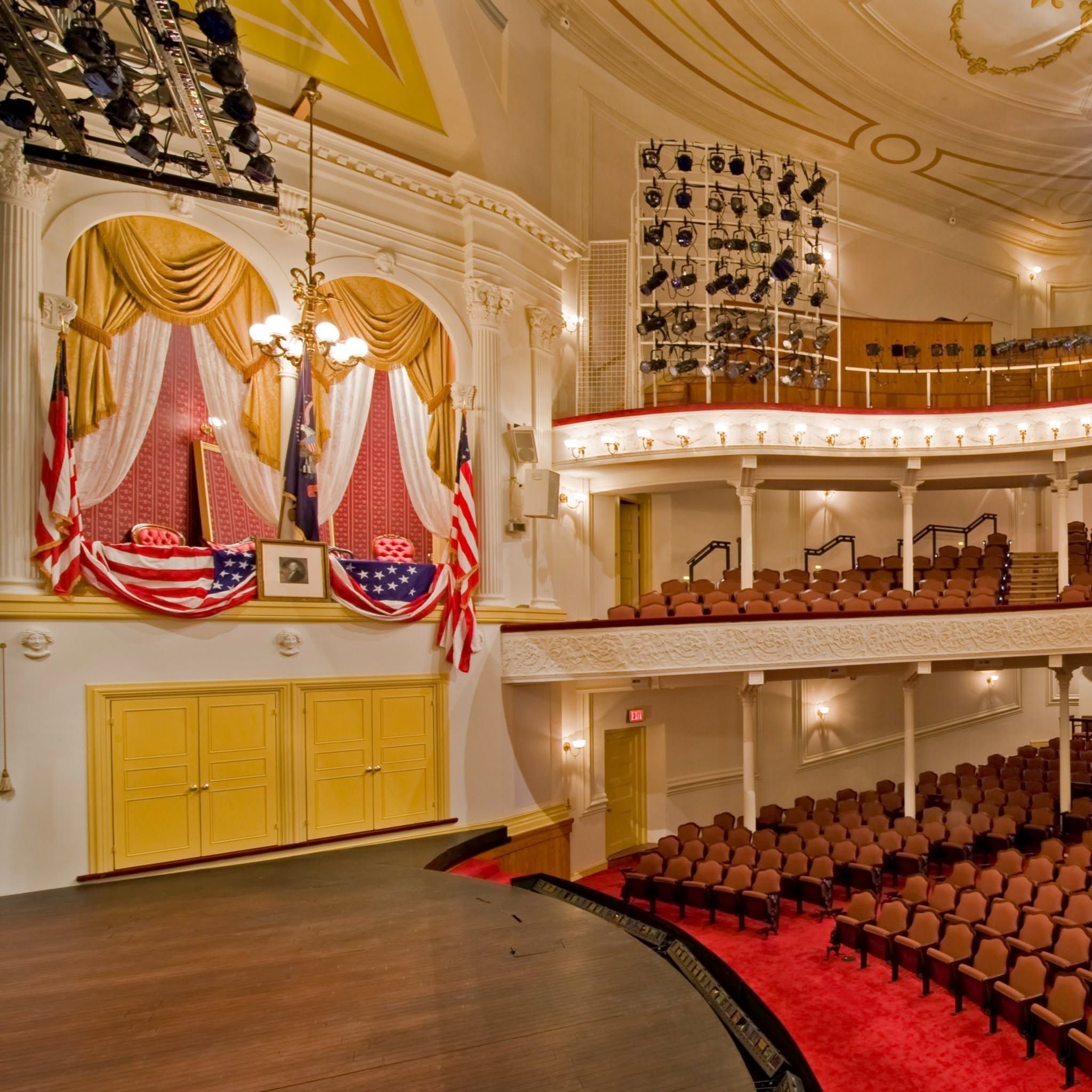 Velvet red curtain at theatre with lights shining on it