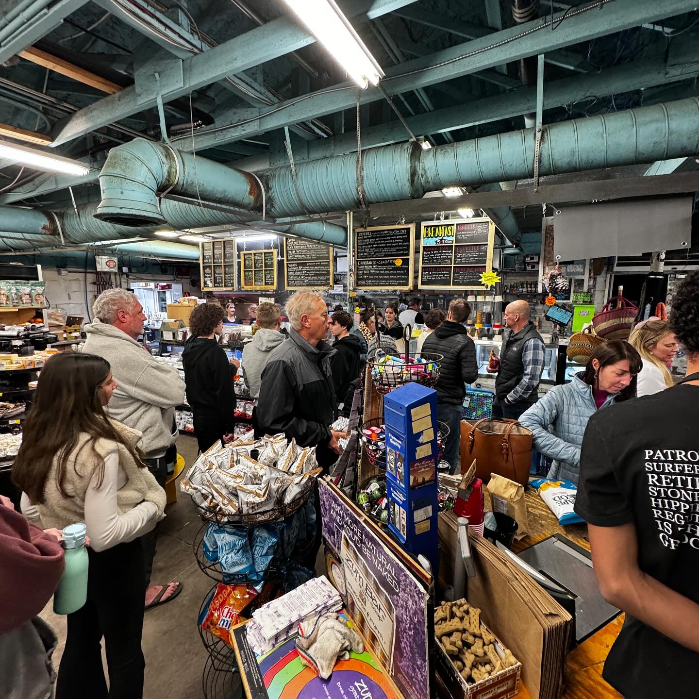 Inside Bert’s Market, shoppers line up at the counter in a busy local grocery and deli. The shelves are packed with snacks, drinks, and beach essentials. This spot is known as a go-to convenience store on Folly Beach.
