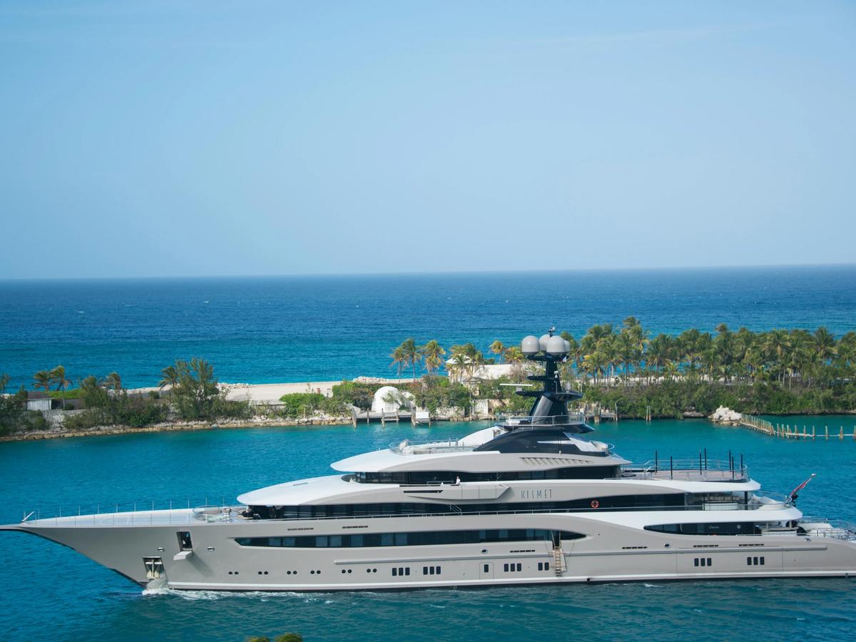 A luxury yacht cruising through the turquoise waters of the Bahamas. Boats and ferries are popular ways to hop between islands and explore hidden cays.