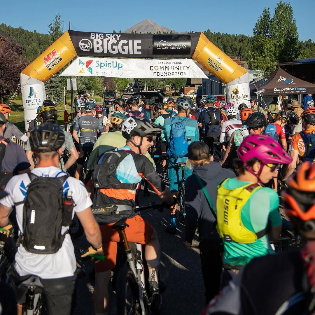 Cyclists line up under the start banner for the Big Sky Biggie mountain bike race. The crisp mountain air and scenic backdrop set the tone for an epic day of endurance and adventure.