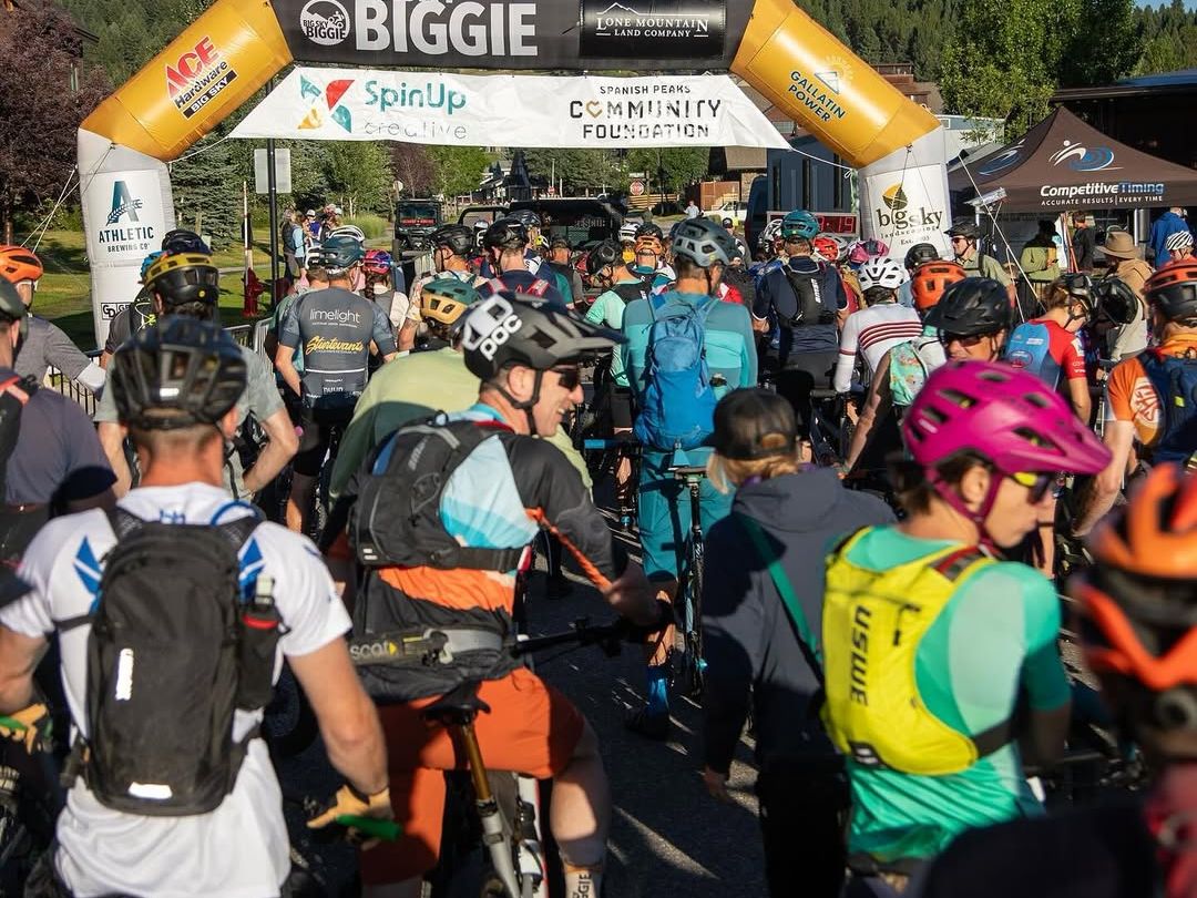 Cyclists line up under the start banner for the Big Sky Biggie mountain bike race. The crisp mountain air and scenic backdrop set the tone for an epic day of endurance and adventure.