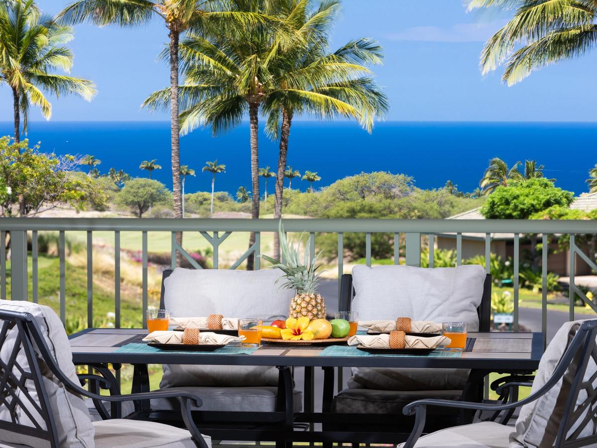Balcony dining with fruit plate and palm trees and ocean views