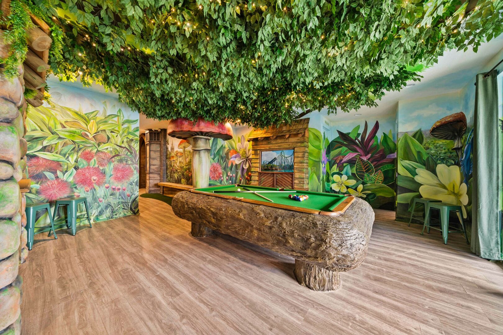 Fairy-field and outdoor themed game room with pool table and flowers on the wall