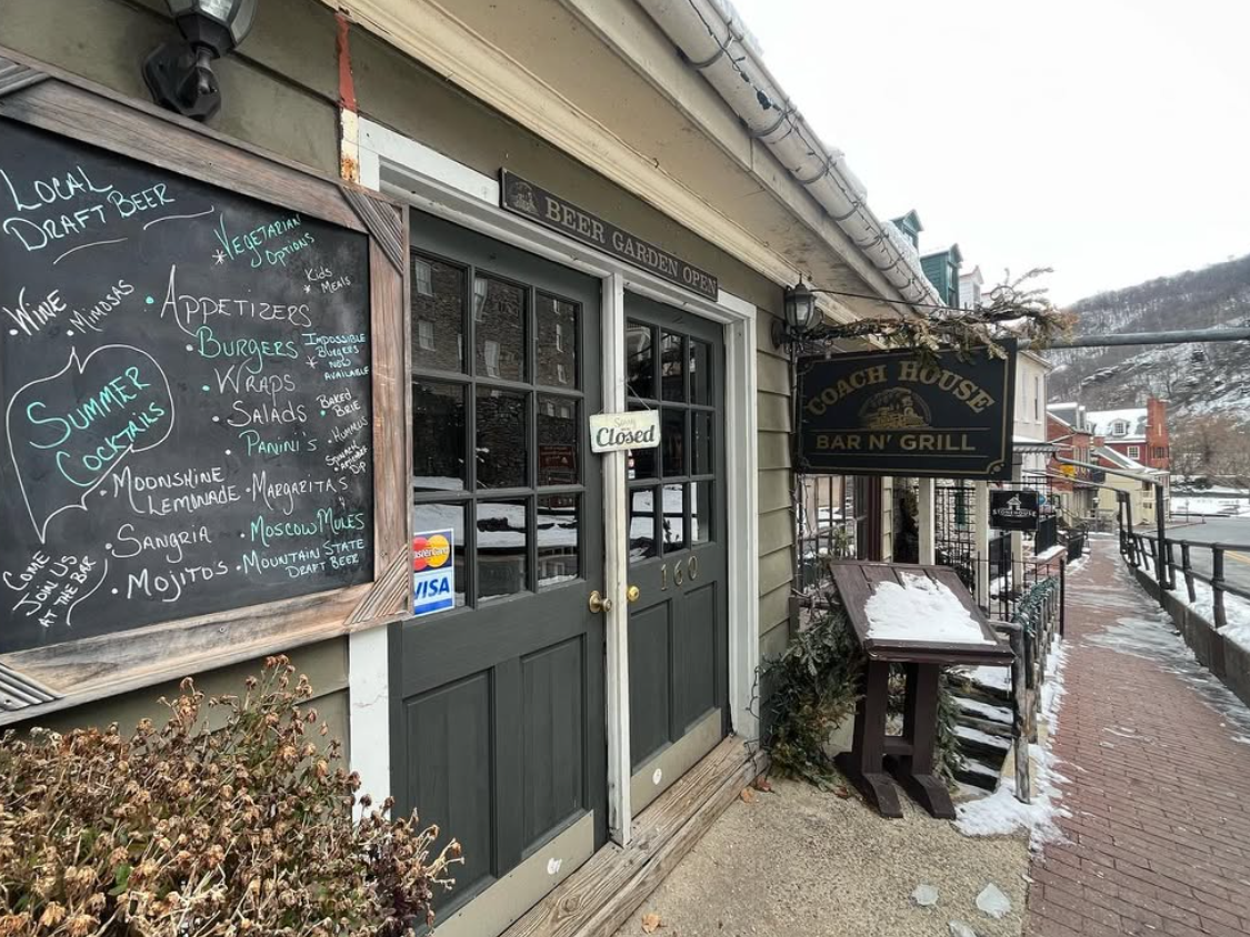 Exterior of restaurant in West Virginia with chalk board sign out front and light snow on the ground