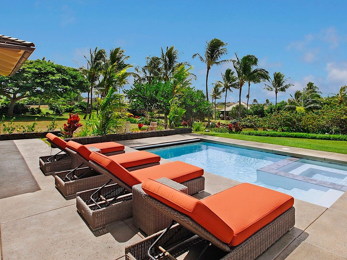 Lounge Chairs on the side of A Private Pool at A Luxury Kauai Vacation Rental