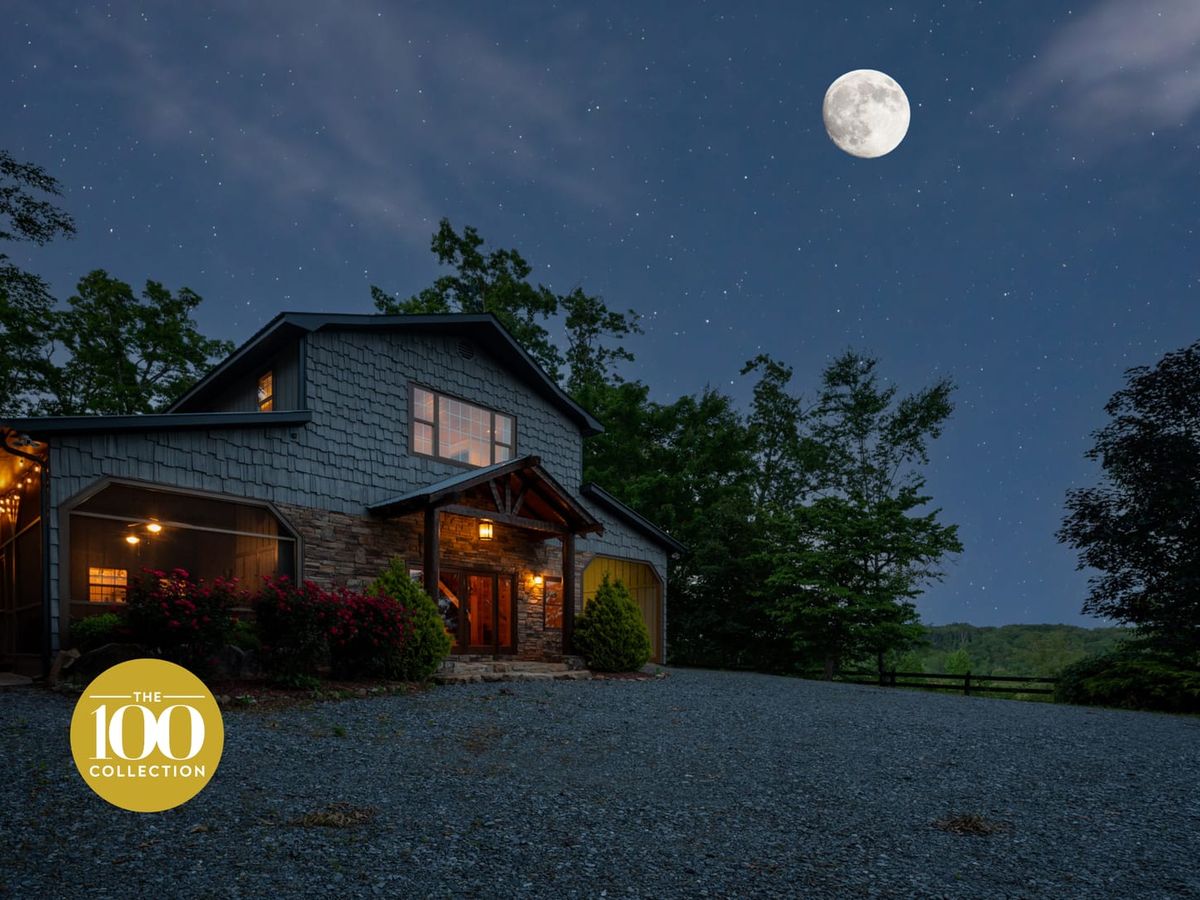 Cabin in blue ridge, ga with dark, starry night stars with bright moon overlooking cabin