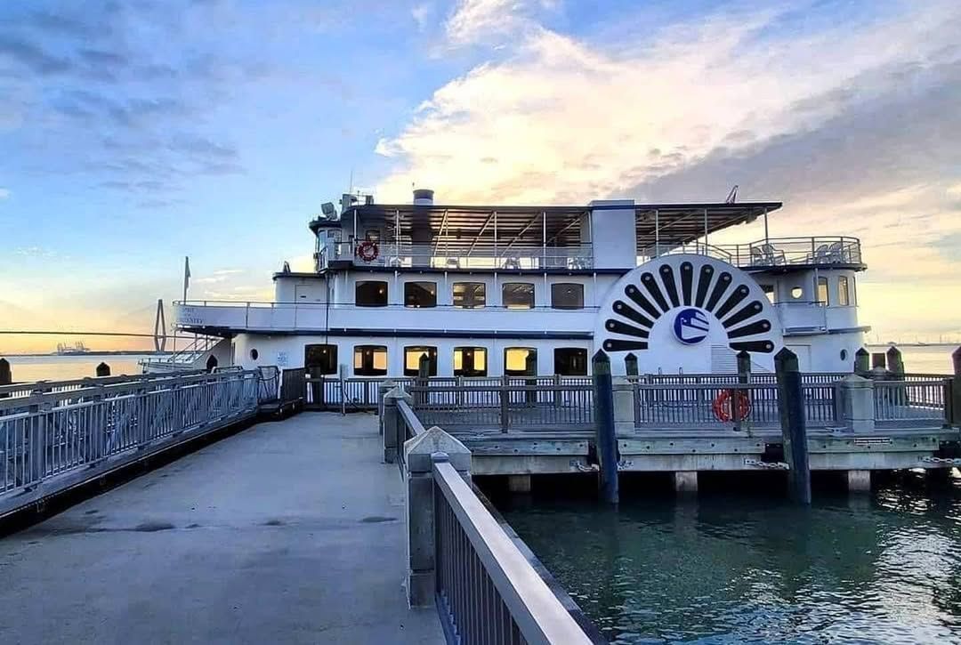 A large tour boat docks at Fort Sumter, where history buffs explore one of Charleston’s most famous landmarks. The fort stands proudly against the harbor backdrop, known for its role in the Civil War.