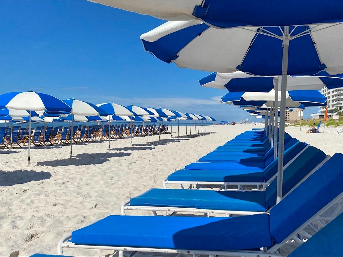 Beach Chairs and umbrellas on beach at Lost Key Golf & Beach Club