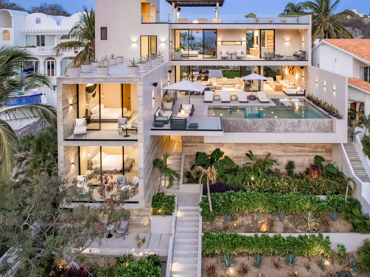 Nestled by the ocean, this bright hillside villa offers breathtaking coastal views, a curved infinity pool, and lush gardens. The perfect escape for beach lovers craving luxury and nature.