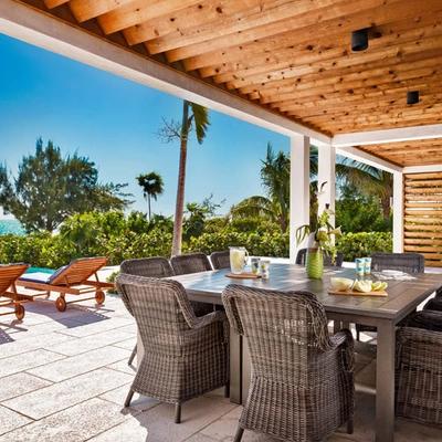 Outdoor dining space poolside at a Turks and Caicos vacation rental.
