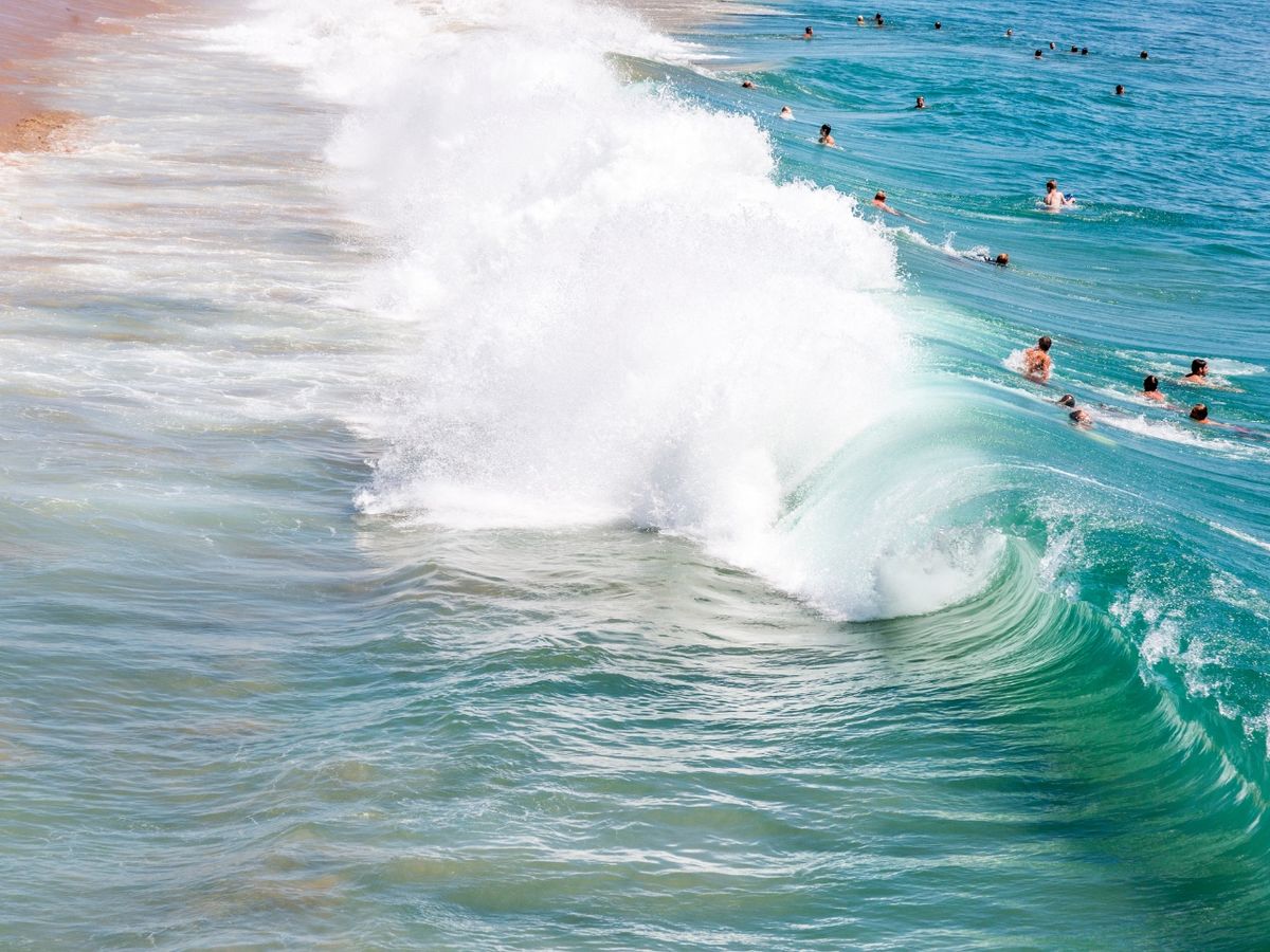 Surfers and wave in Newport Beach, CA