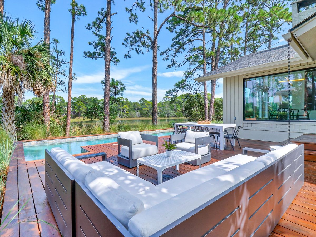 Hilton Head Island Rental Back Deck with Outdoor Seating, a pool and view of Tidal Marsh