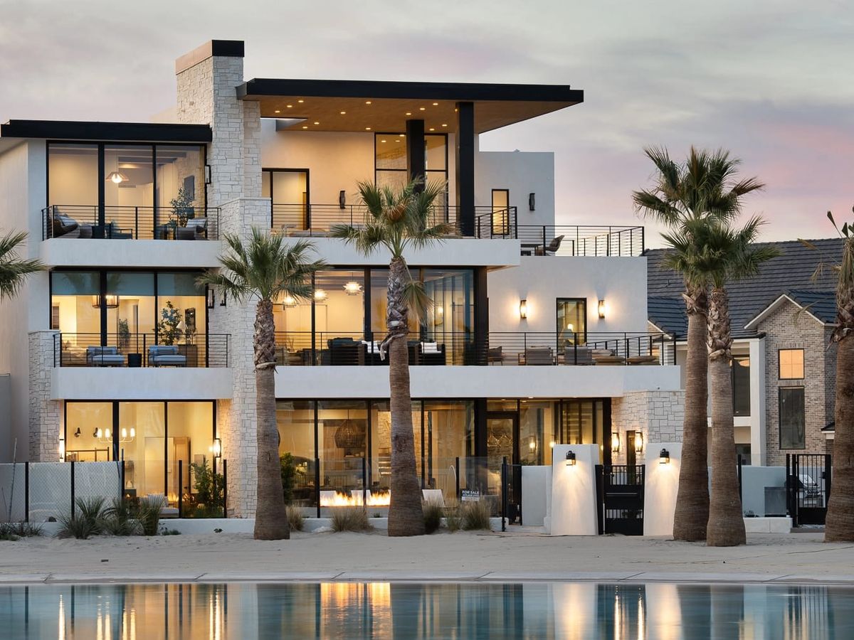 An aerial view of a resort community in St. George, Utah, surrounded by red rock cliffs and family-friendly pools. The mix of modern vacation homes and desert scenery makes it a perfect spot for group getaways.