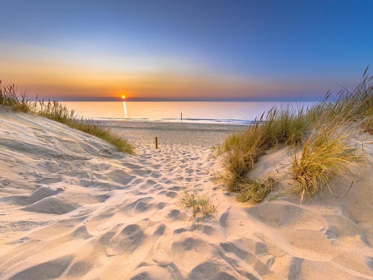 View of Sunset and the ocean from sand dune at Ocean Isle Beach, NC
