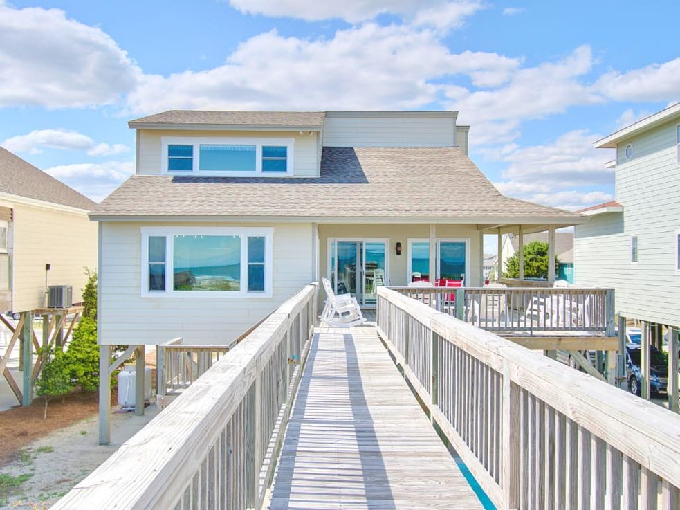 A classic oceanfront home with a long wooden walkway leading straight to the beach. Its spacious deck and large windows offer stunning ocean views—perfect for sunrise coffee or sunset gatherings.