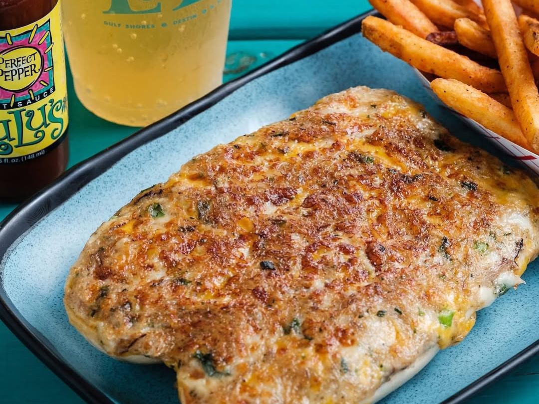 Cheesy seafood dip baked to golden perfection, served with crispy fries and cold beer at LuLu’s. A Gulf Shores favorite with bold flavors and beach vibes.