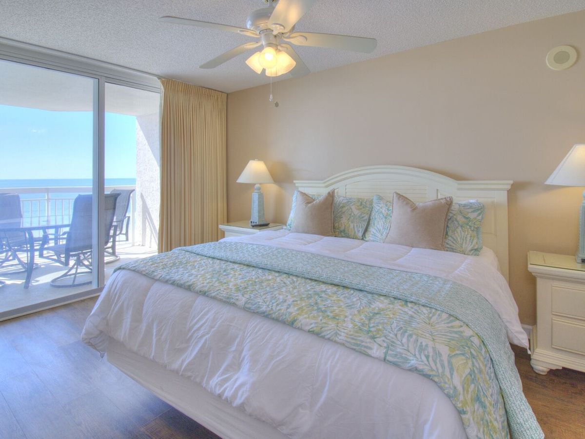 Peaceful master bedroom with soft beachy tones, fluffy bedding, and sliding glass doors that lead straight to the balcony. You’ll wake up to sunlight and ocean views every morning.