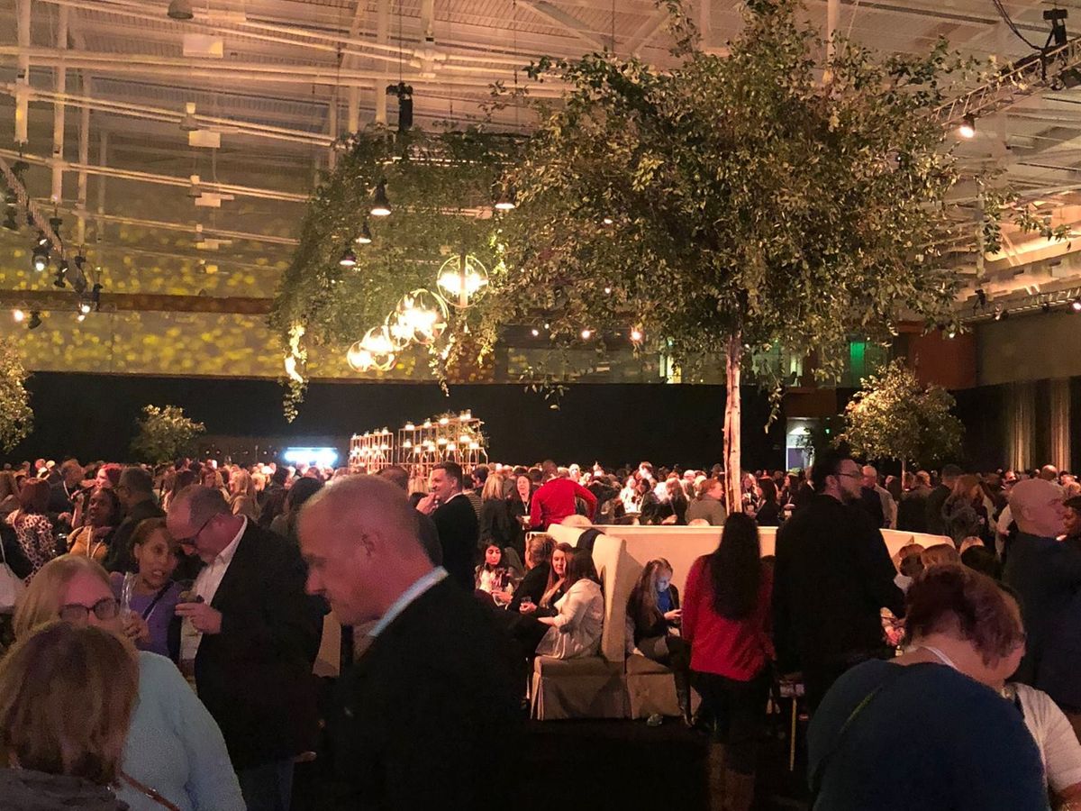 A lively rooftop party at Hyatt Nashville with guests dressed up, chatting, and enjoying drinks under warm city lights. This stylish venue is popular for nightlife, social events, and skyline views in downtown Nashville.