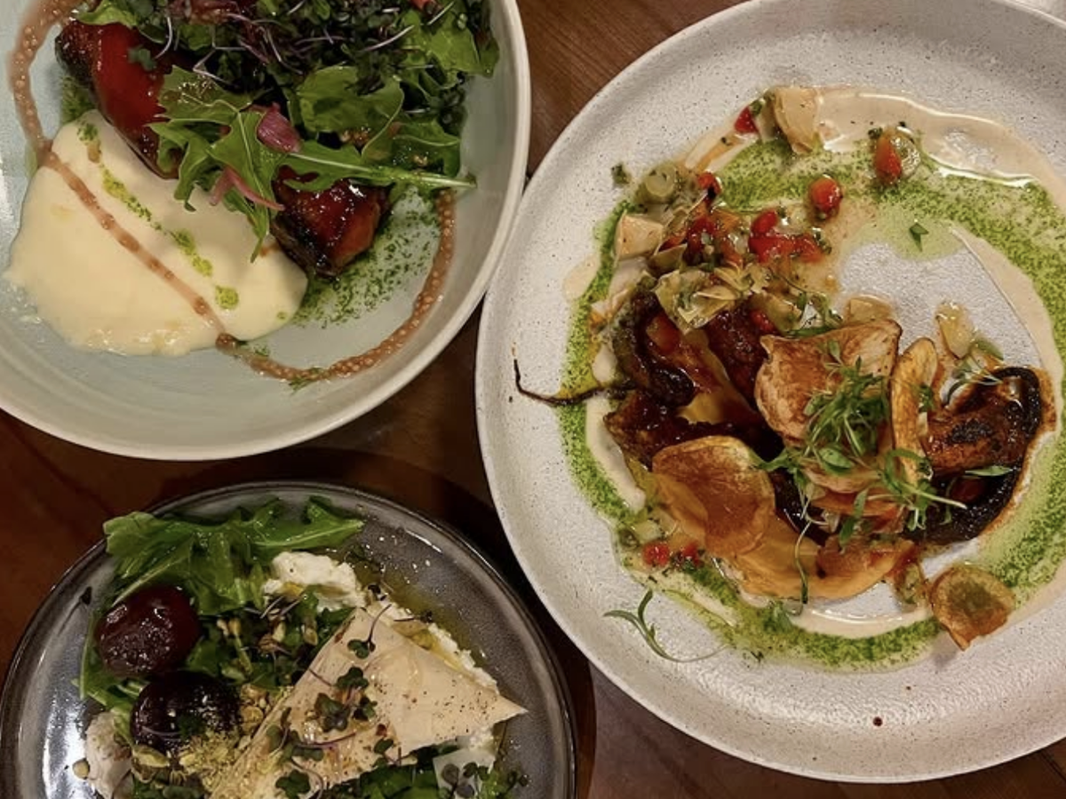 Three elegantly plated dishes featuring vibrant farm-to-table ingredients: roasted vegetables with microgreens and a creamy purée, grilled octopus or mushrooms with colorful relish and herb oil, and a beet salad with whipped cheese, pistachios, and crisp phyllo.