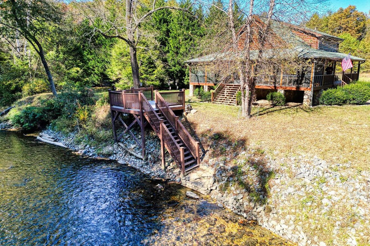 Exterior view of a riverfront cabin rental in Suches, GA.