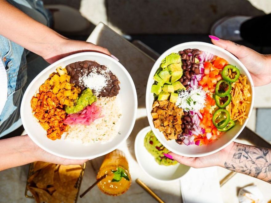 Two colorful bowls from Tocaya Organica, topped with rice, beans, fresh veggies, and guacamole. The bright, fresh ingredients reflect the restaurant’s modern take on healthy Mexican cuisine.