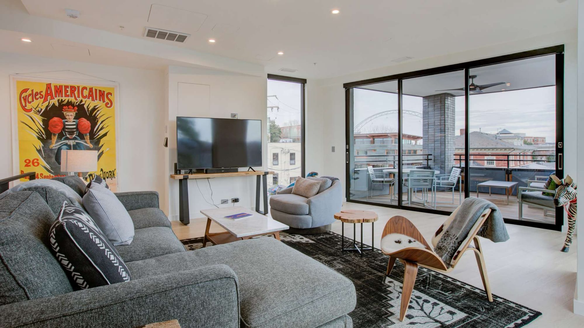 A stylish Charlottesville condo with large windows, modern furniture, and a private balcony. The open-concept layout combines comfort and sophistication, ideal for a weekend getaway.