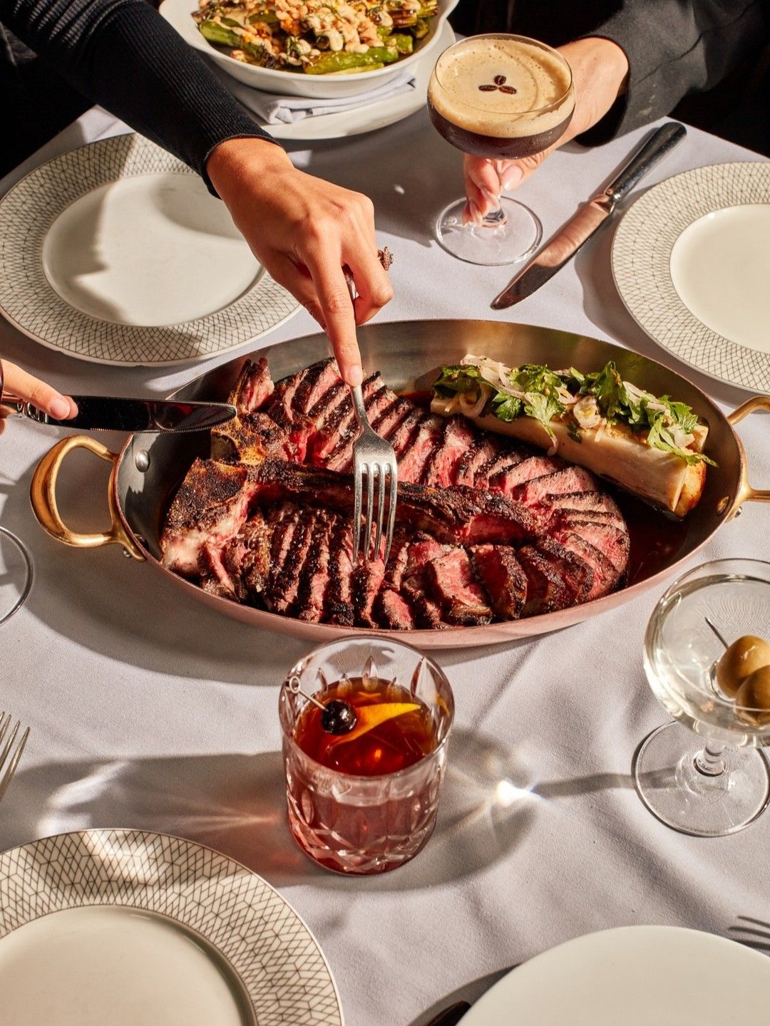A perfectly sliced steak is served tableside at Maple & Ash, a high-end steakhouse in Scottsdale. The upscale setting and bold flavors make it a top choice for luxury dining experiences.