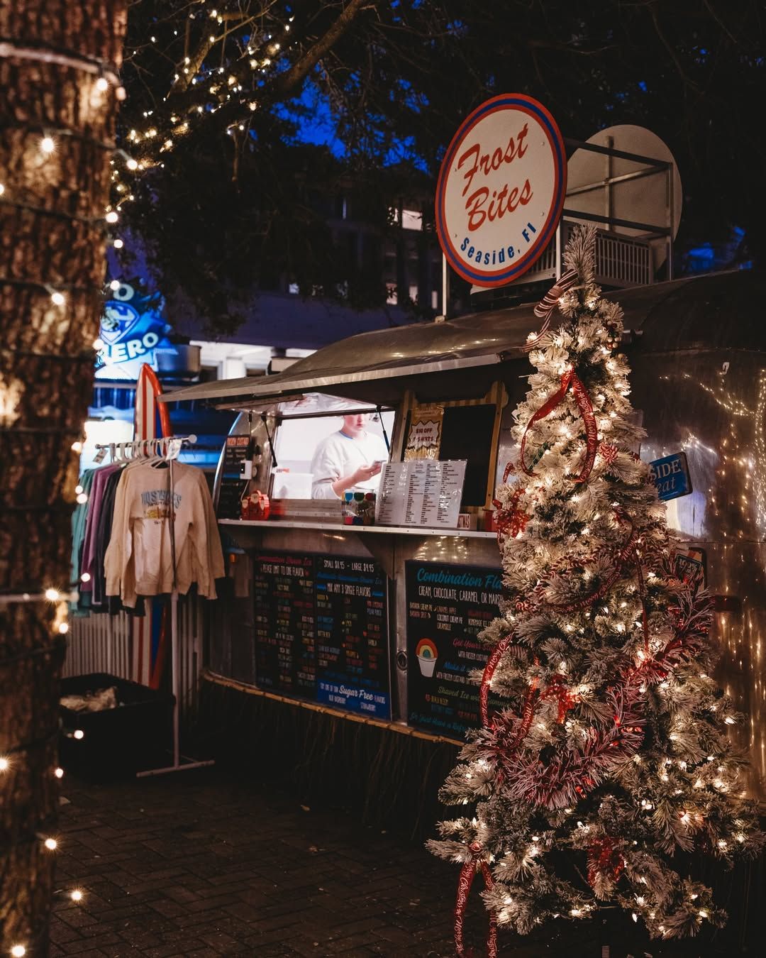 The South Walton Holiday Market features local vendors, handmade gifts, and festive decorations under glowing lights. Visitors stroll through the market, shop for unique holiday finds, and enjoy the cozy Christmas atmosphere in South Walton.