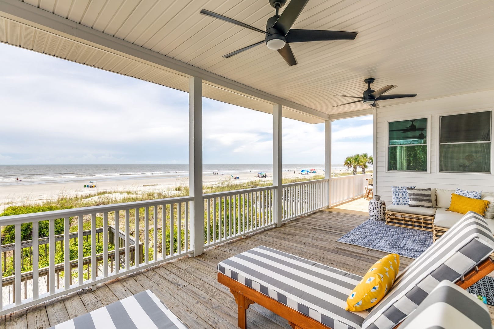 Balcony with striped lounge chairs and beachfront views