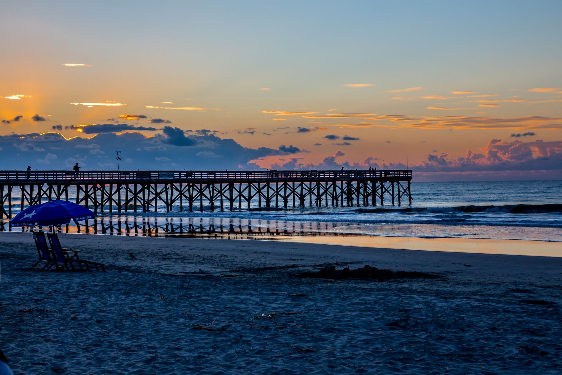 Sunset over the pier at Isle of Palms at Charleston, South Carolina.