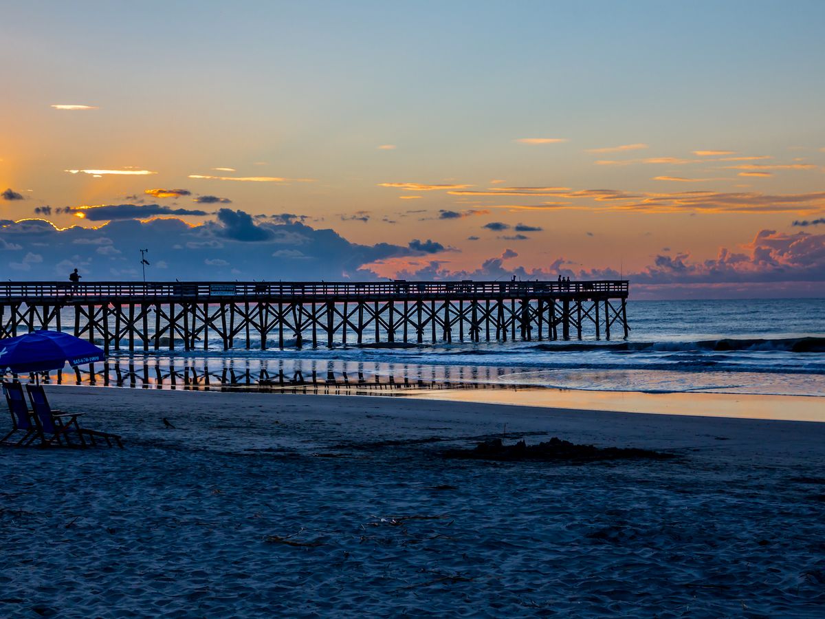 Sunset over the pier at Isle of Palms at Charleston, South Carolina.