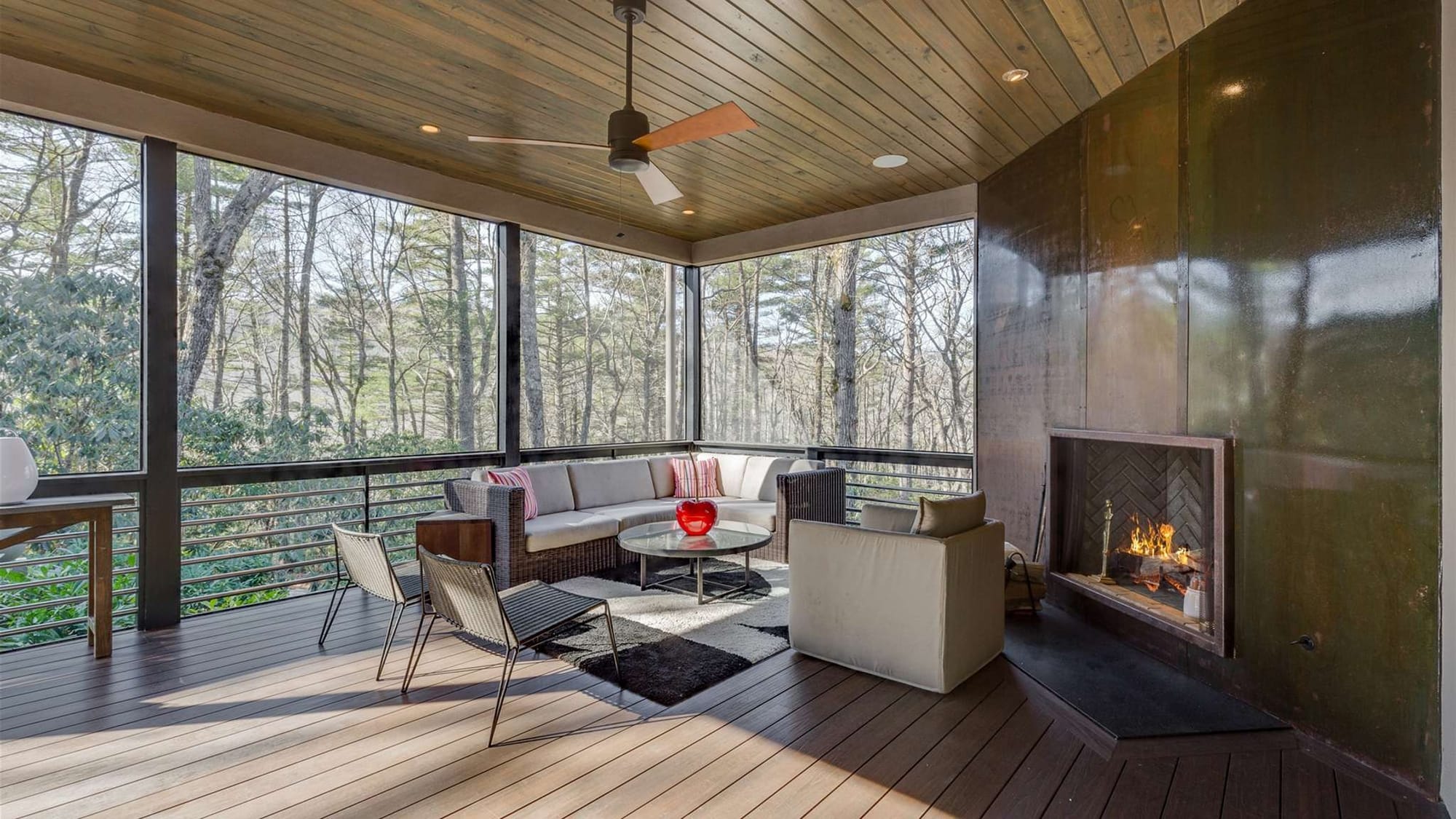 This inviting mountain cabin features high ceilings, wood beams, and a stone fireplace in a bright open living area. Large windows bring in beautiful forest views and natural light. It’s the perfect place for a cozy and comfortable mountain vacation.