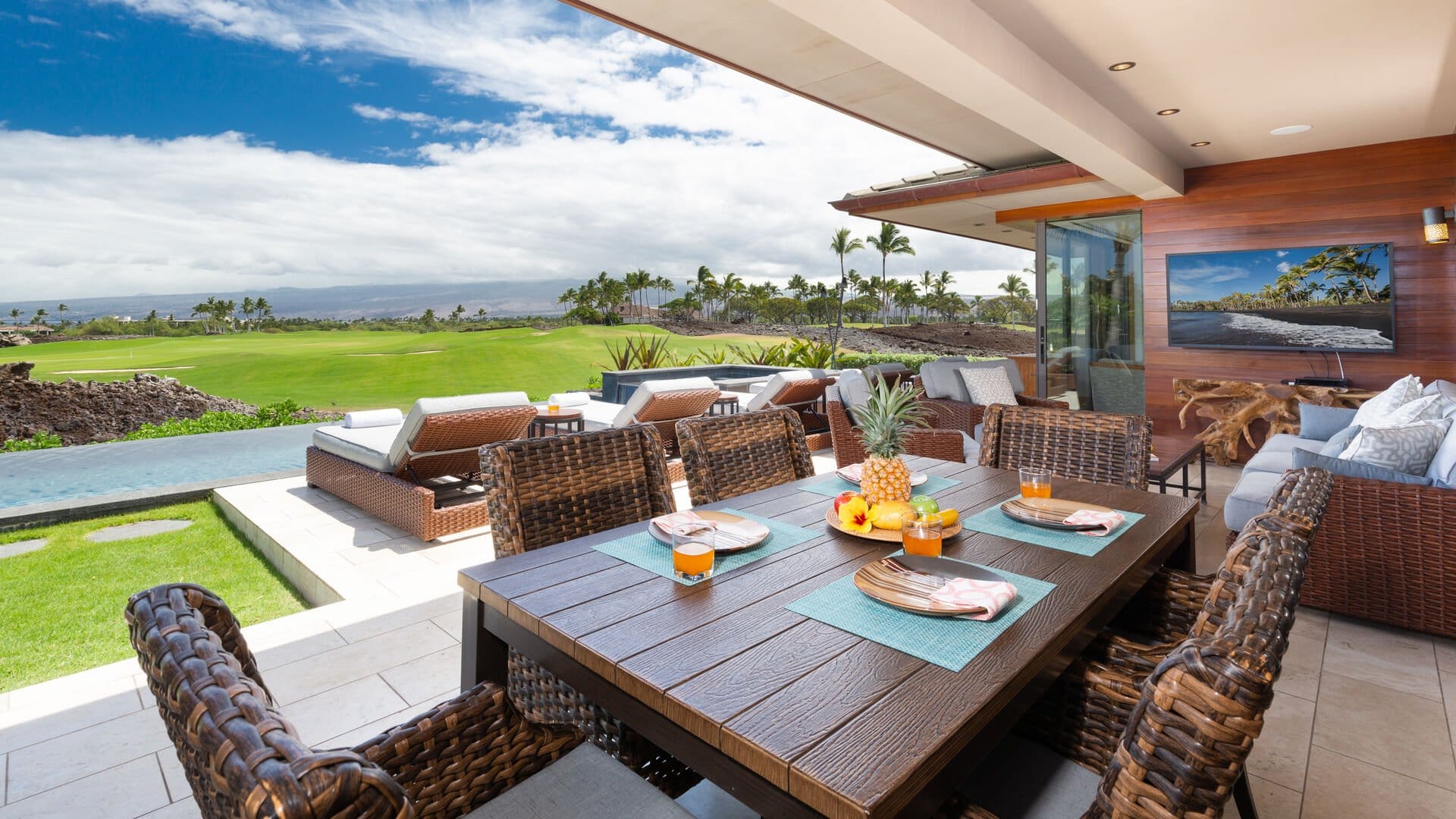 This oceanfront home sits right on the edge of the water, with tall palm trees swaying in the breeze. The open deck and large windows make the whole place feel bright and peaceful, perfect for slow mornings and sunset views.