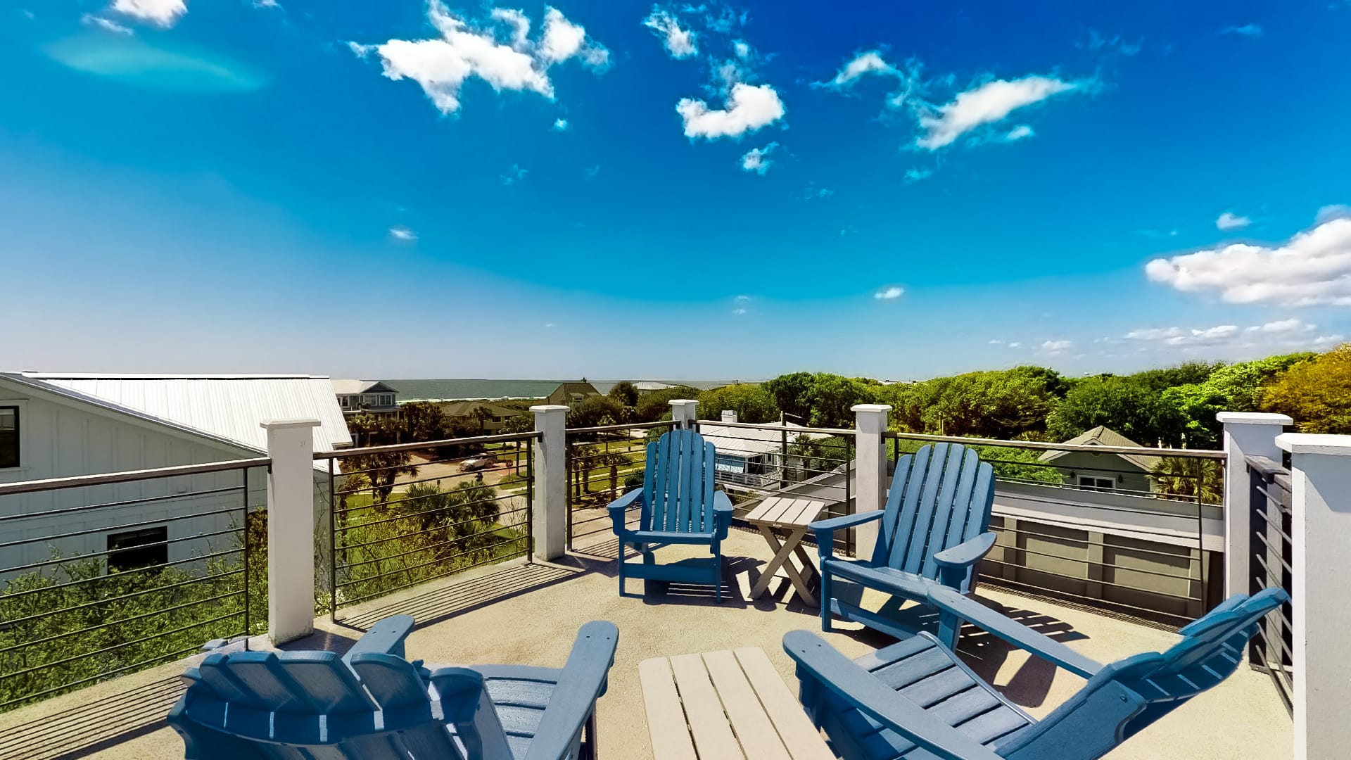 4 blue chairs on rooftop terrace overlooking isle of palms area