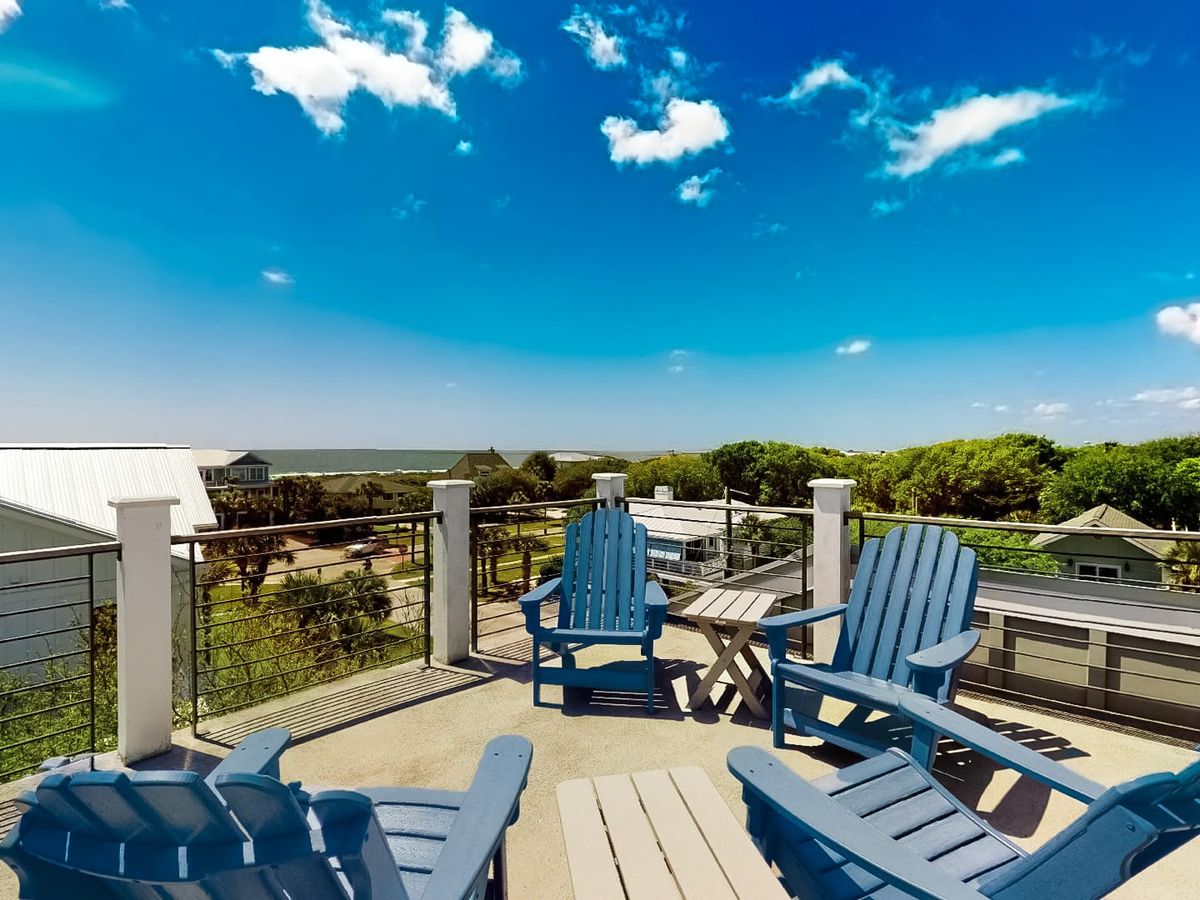 4 blue chairs on rooftop terrace overlooking isle of palms area