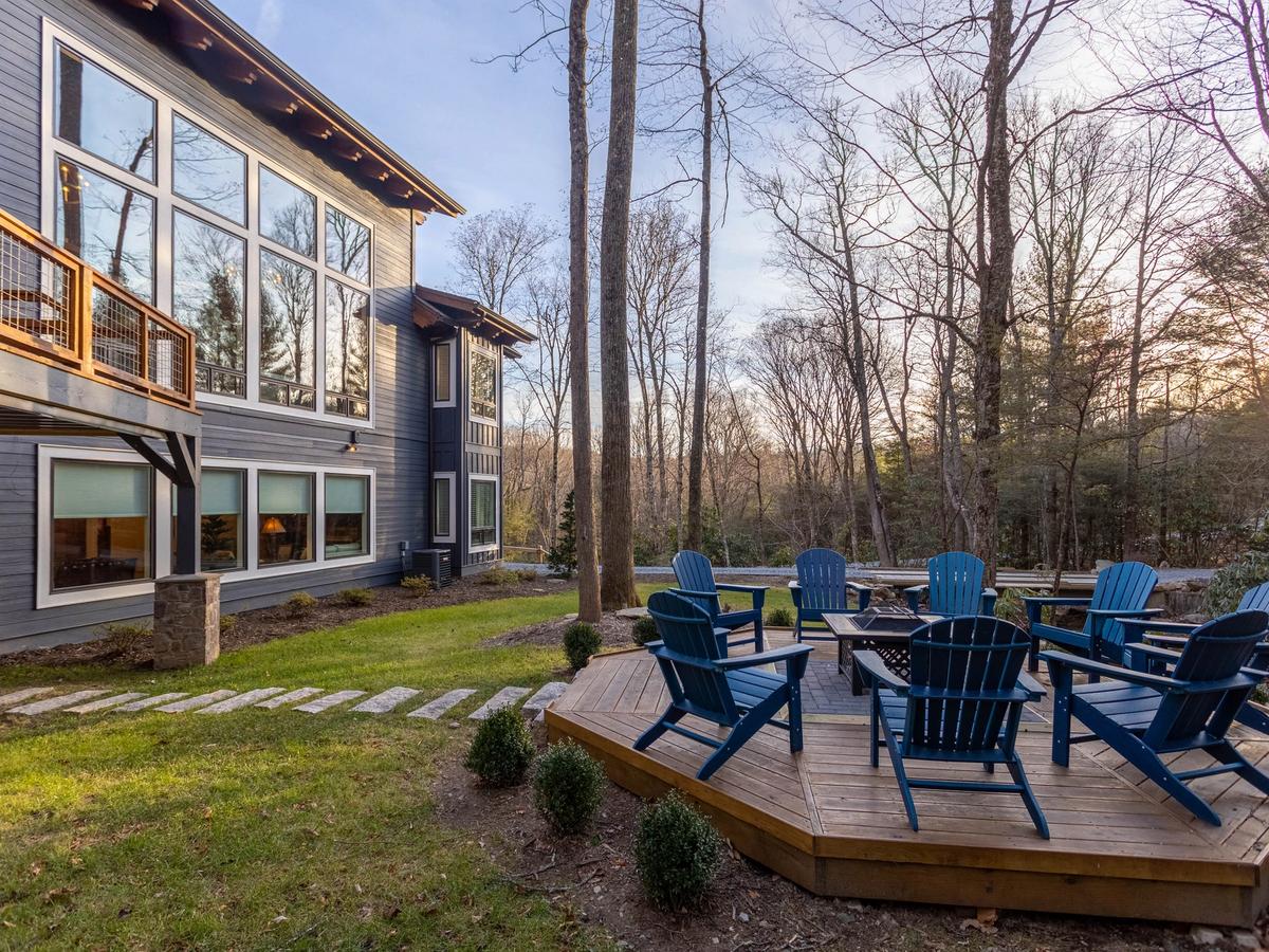Outdoor firepit with blue chairs in the backyard of home