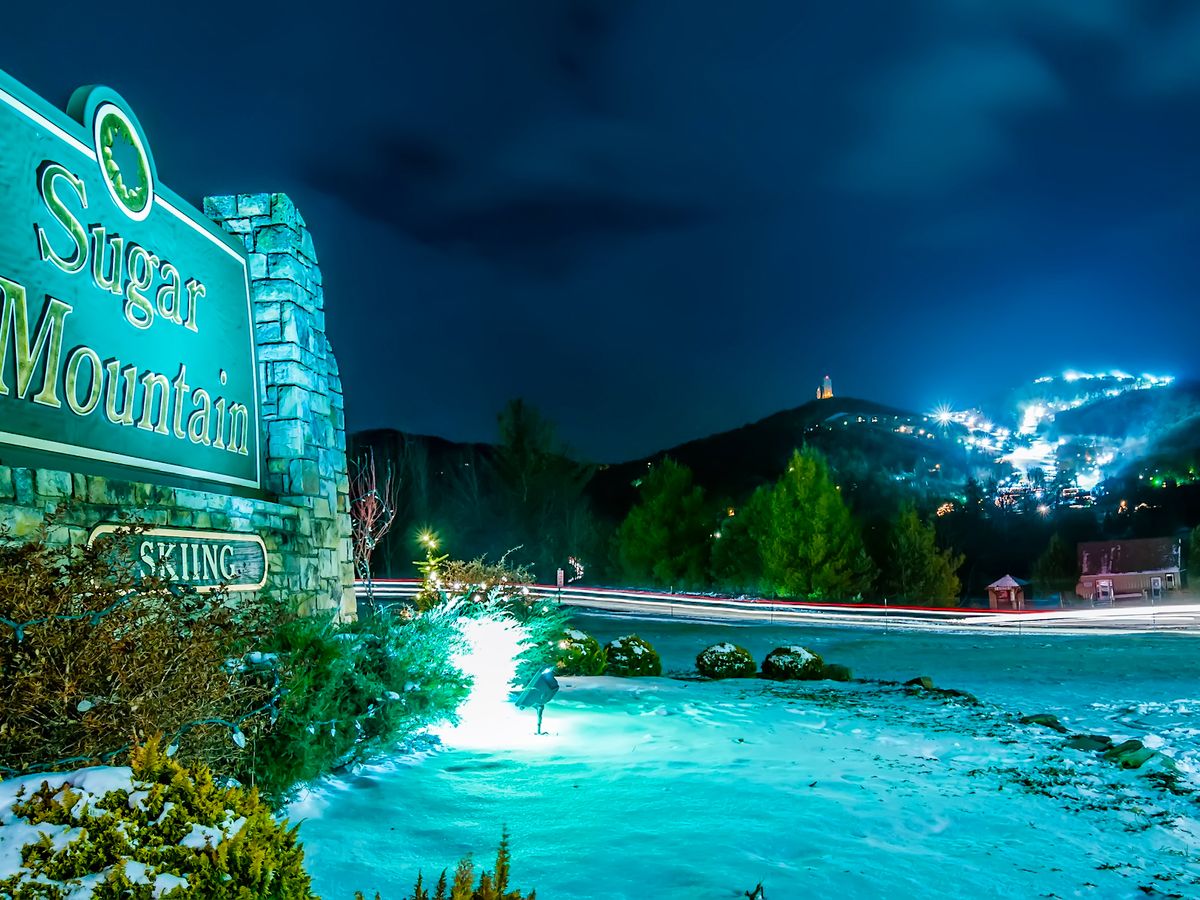 Sugar Mountain Ski Resort Sign in North Carolina At Night With Lights on Ski Hill