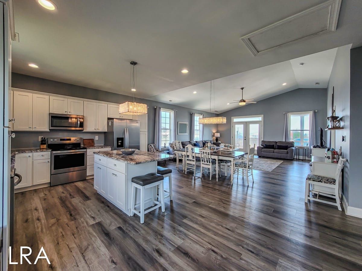 This Surf City rental offers ocean and sound views, two decks, and a breezy open layout made for groups and pets. The soft blue and white decor, plus a fully stocked kitchen, make it easy to unwind after beach days.