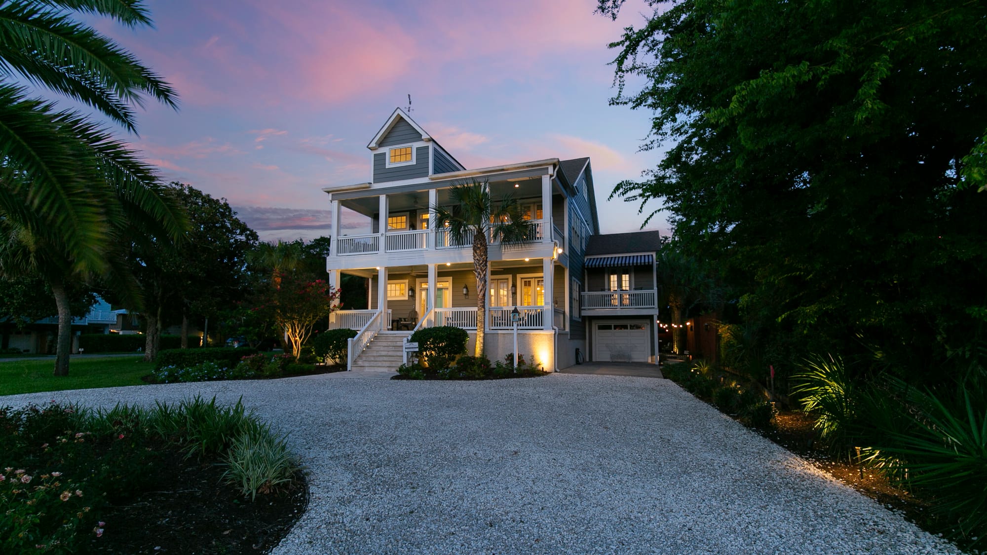 A stunning coastal home with wraparound porches, palm trees, and soft pink skies at sunset. Perfect for families or groups, it offers the charm of Southern architecture near St. Simons Island’s beaches.