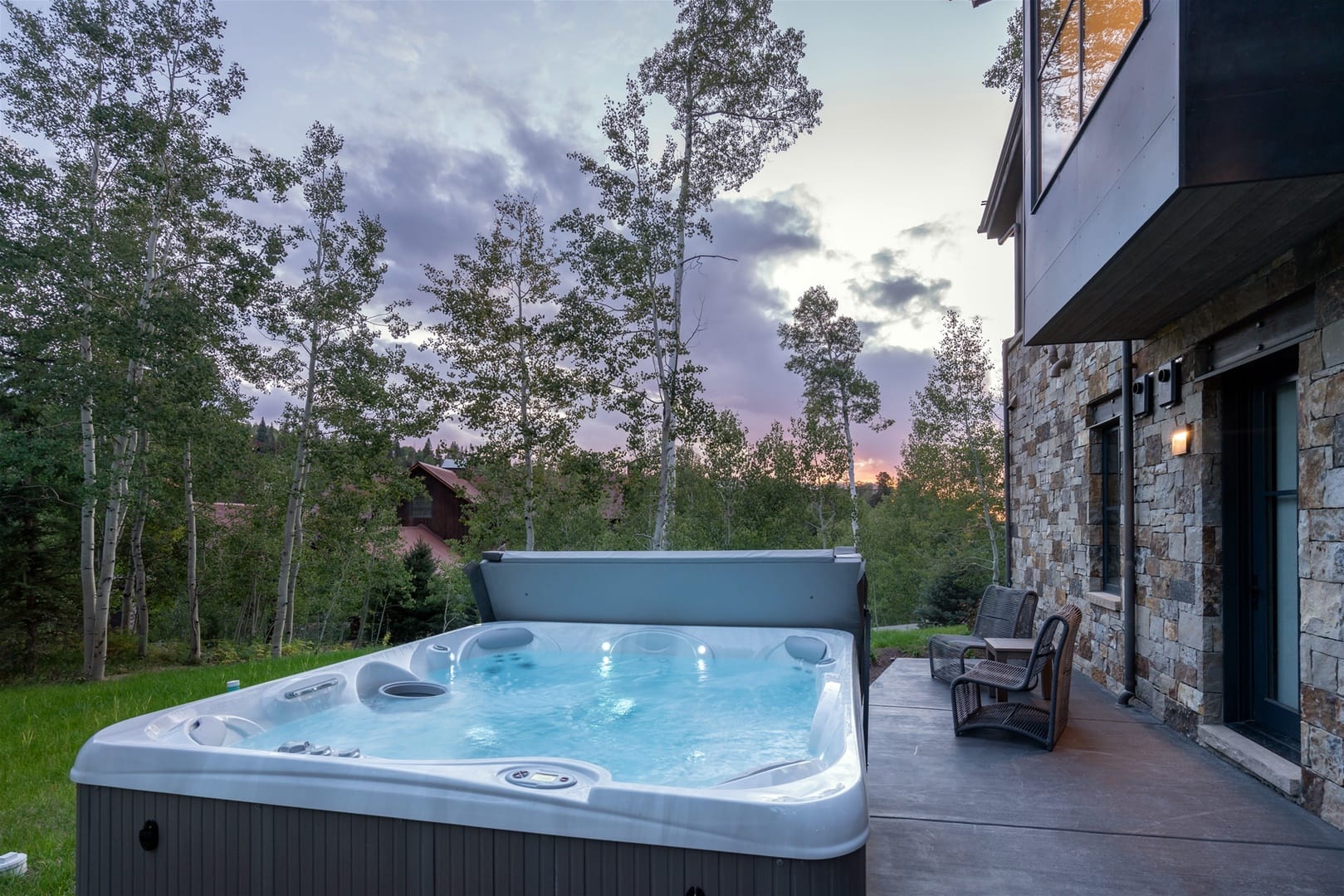A sophisticated mountain home framed by aspen trees and snow-capped peaks. With high-end finishes, large windows, and an inviting fireplace, it’s a serene escape for families and friends year-round.
