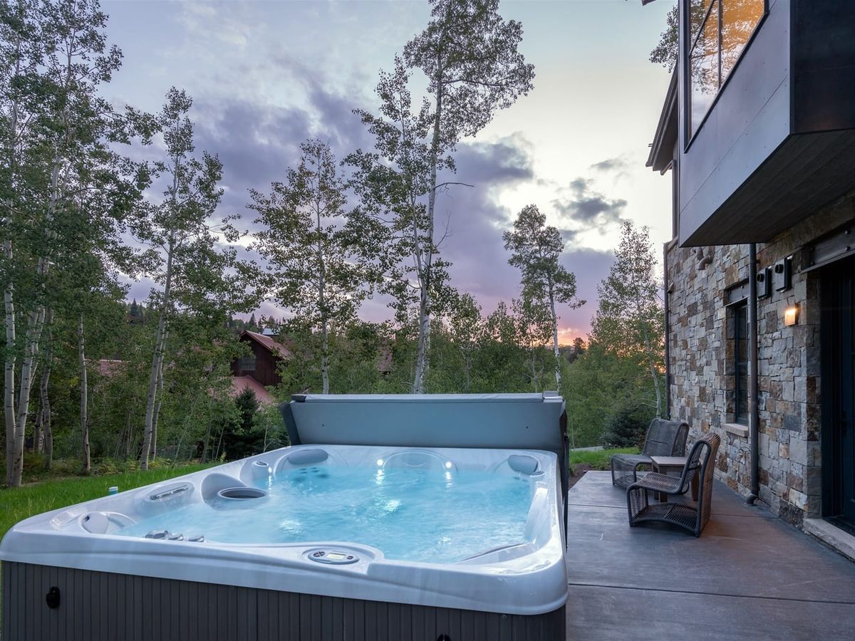 A sophisticated mountain home framed by aspen trees and snow-capped peaks. With high-end finishes, large windows, and an inviting fireplace, it’s a serene escape for families and friends year-round.