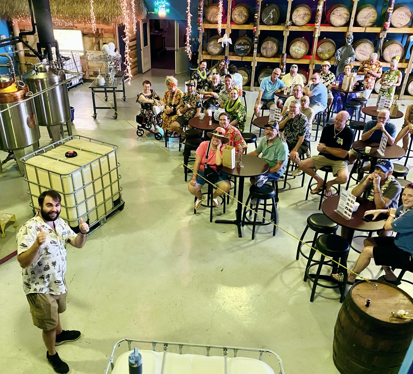 Guests enjoy a lively rum tasting experience at a Siesta Key distillery, surrounded by barrels and tropical décor. This indoor tour gives you a behind-the-scenes look at how local rum is made while you sip and relax with friends.