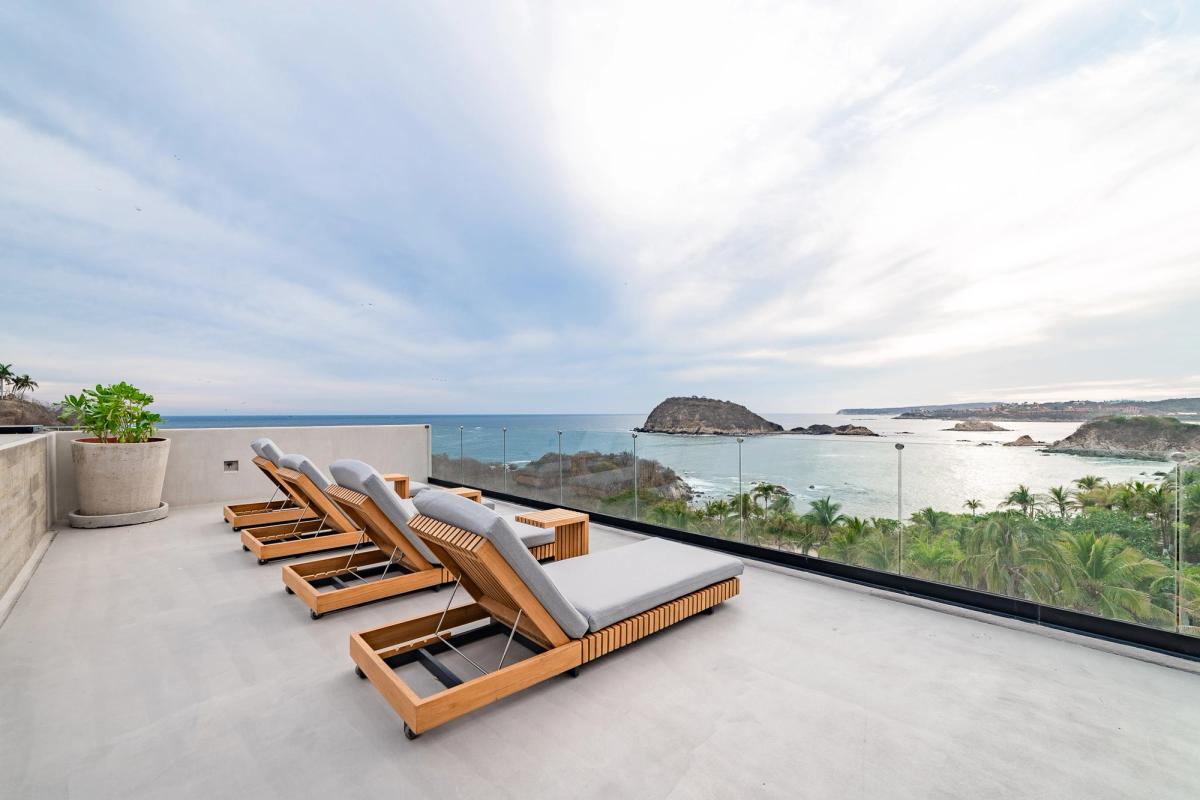 Outdoor living space with sea views at La Montosa.