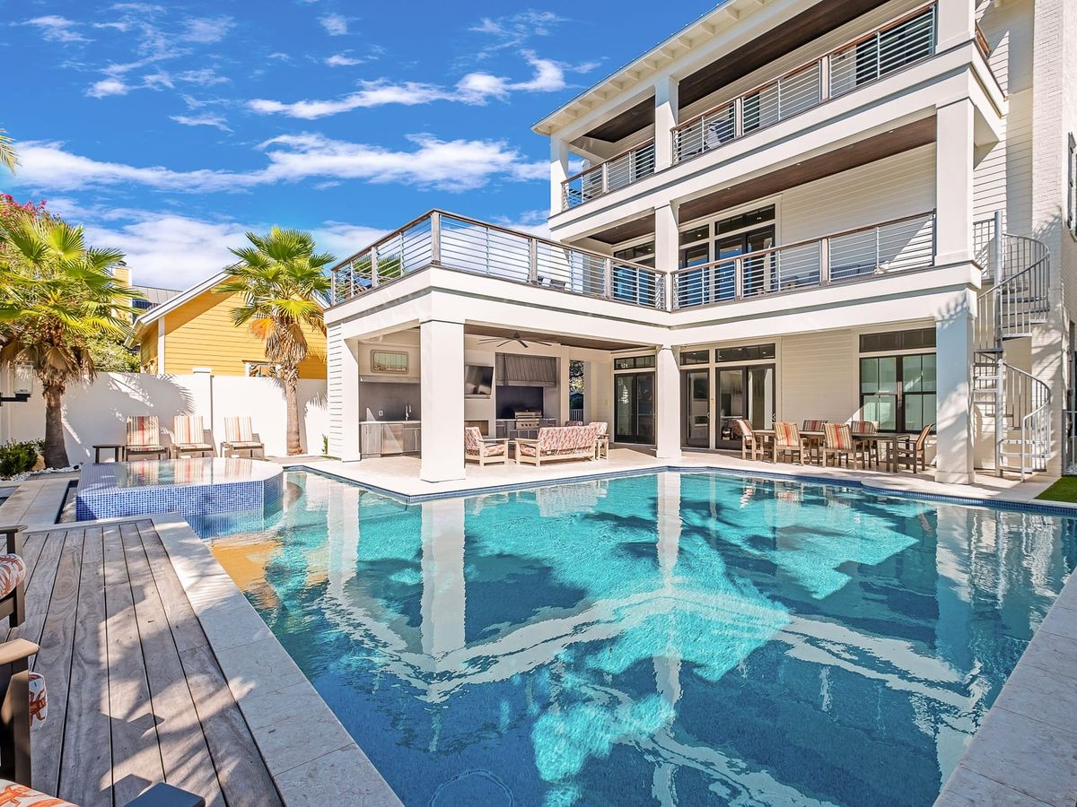 Luxury vacation home with private pool, spacious outdoor seating, and modern design, perfect for hosting large groups in style.