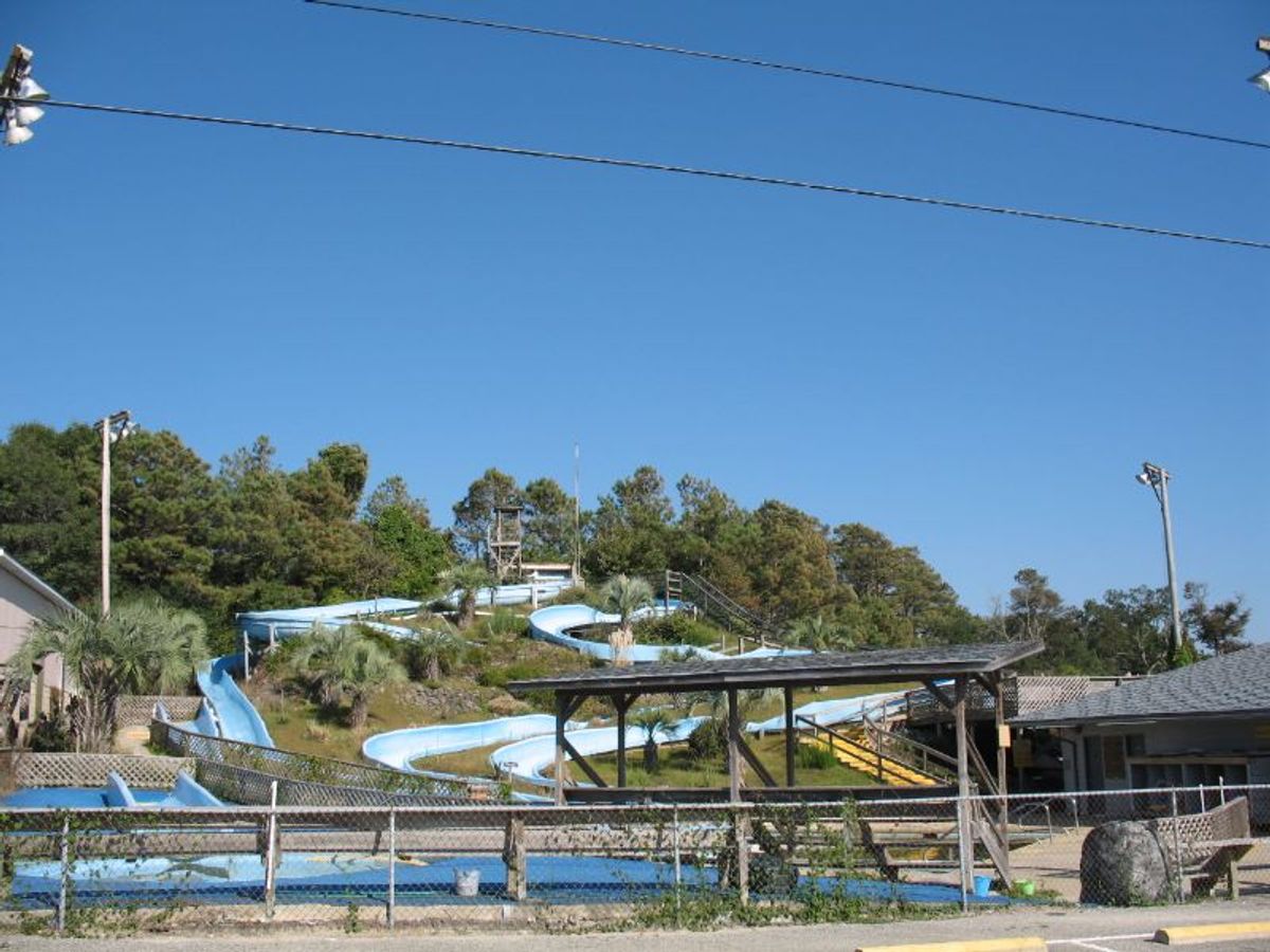 Blue water slides twist through the trees at Magic Mountain Fun Park, a classic family spot for cooling off and having fun in Holden Beach.