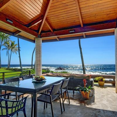 Private lanai with view of ocean and palm trees